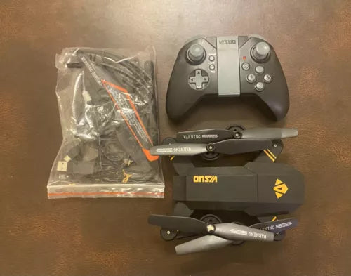 Visuo 4-channel camera drone with gray remote controller and propeller arms
