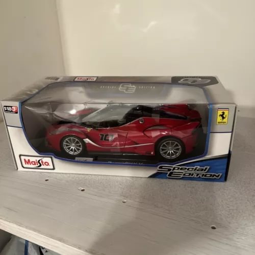 Red and black diecast sports car model in display box, 1:18 scale