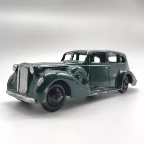 Vintage dark green diecast saloon sedan car with four-door body