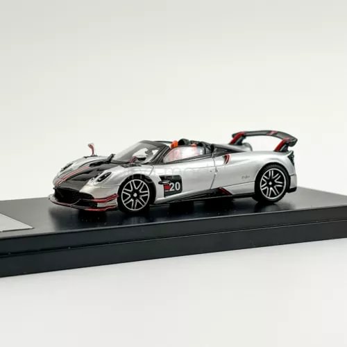 Silver diecast sports car model with black hood, red accents, and #20 on door