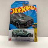 Green and gray Hot Wheels Ford Transit Connect diecast van toy with black wheels