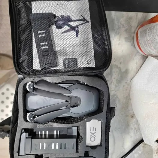 Exo Ranger drone in open zip case with remote and landing pod