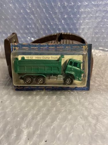 Green diecast tandem dump truck toy in clear retail box