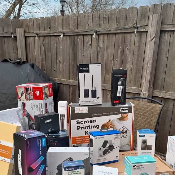 Assorted boxed electronics and screen-printing devices on a table