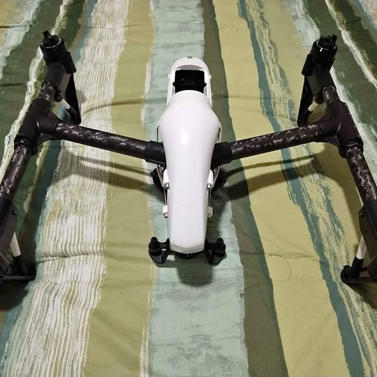 DJI Inspire 1 drone with white body and black arms, showing four propellers