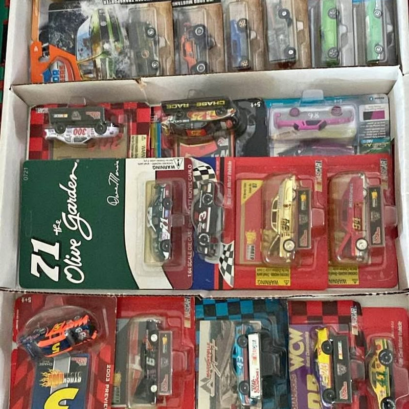 Assorted diecast cars in blister packaging inside a retail display box
