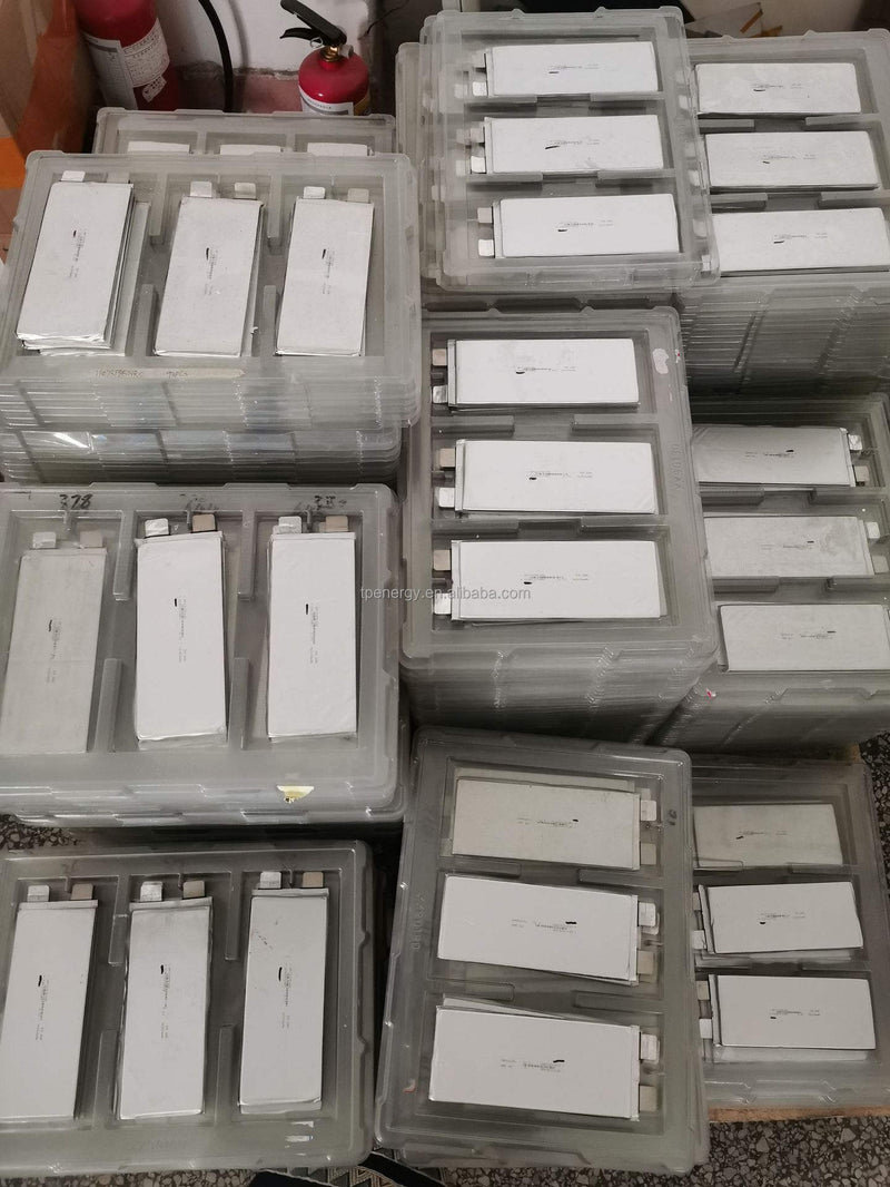 Drone LiPo battery cells in clear plastic trays, multiple white packs
