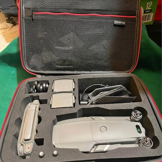 Gray drone hard case with drone, controller, batteries, and accessories