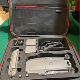 Gray drone hard case with drone, controller, batteries, and accessories