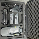 Drone with controller and spare batteries in hard case
