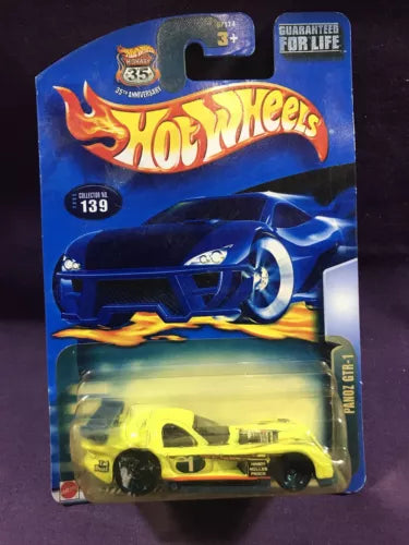 Hot Wheels diecast car in blister pack, yellow race car with black wheels