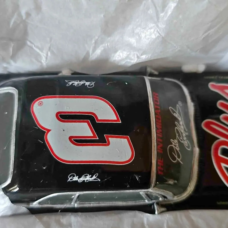 Black diecast stock car with red and white racing logo on side panel