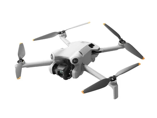 White DJI mini drone with four folding propellers, view from front