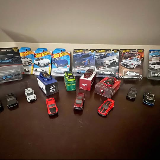 Hot Wheels diecast toy cars in retail packaging, assorted styles and colors