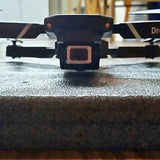 Drone front camera housing with dark body and lens opening
