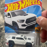 White Toyota Tacoma pickup diecast model, front view with dark grille
