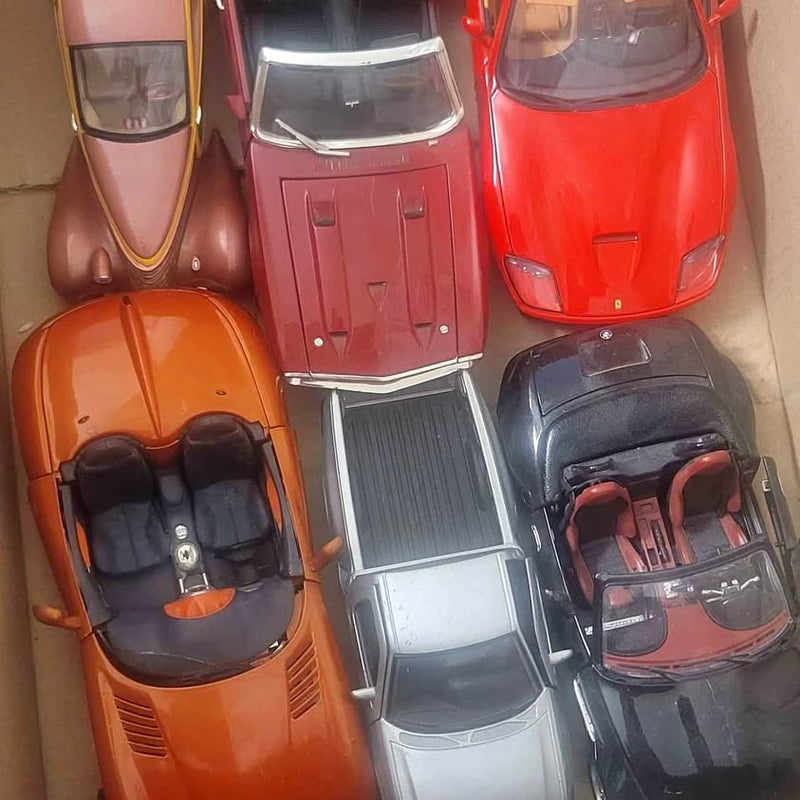 Assorted diecast toy cars in orange, red, brown, gray and black, front views