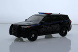 Police SUV diecast model with black body, roof lights, blue stripes, front 3/4 view