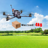 FPV quadcopter drone with four arms and propellers, hovering near a cardboard box