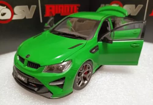 Green alloy diecast sports car model with open door, front 3/4 view.