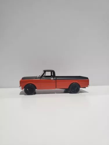 1:64 scale diecast pickup truck, orange with black cab and bed