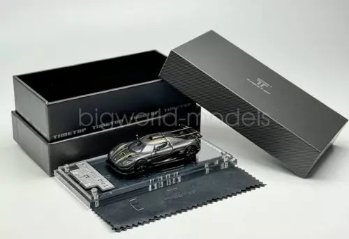 1:64 scale racing sports diecast car model, dark with silver details, in box