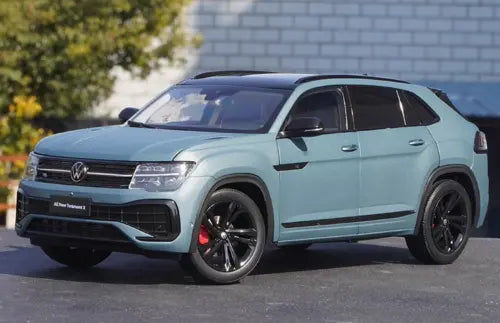 Cyan diecast SUV model car with black alloy wheels, front three-quarter view