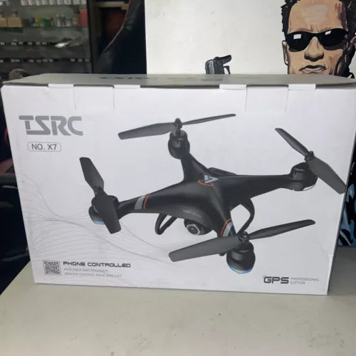 Black quadcopter drone with four propellers shown on product box