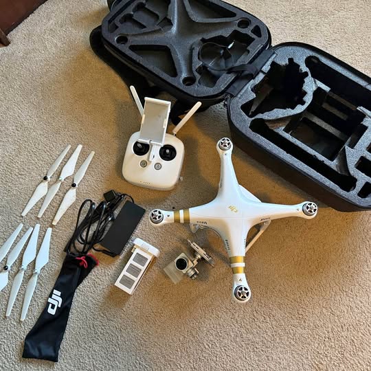 White DJI Phantom 3 Pro drone with four propellers and controller accessories