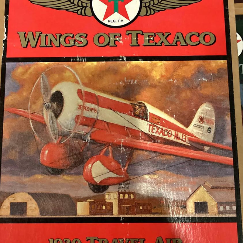 Diecast model plane in red and white with TEXACO lettering on the box