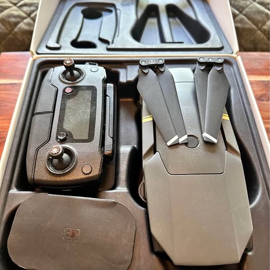 DJI Mavic Pro drone with gray remote controller, joysticks, and folded propellers