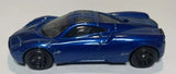 Blue sports diecast model car, side view with black wheels