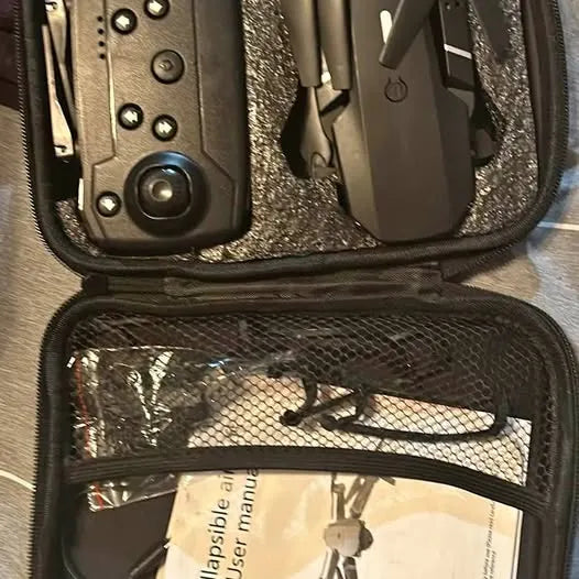 Dark zippered carry case with mesh organizer and wrapped drone component