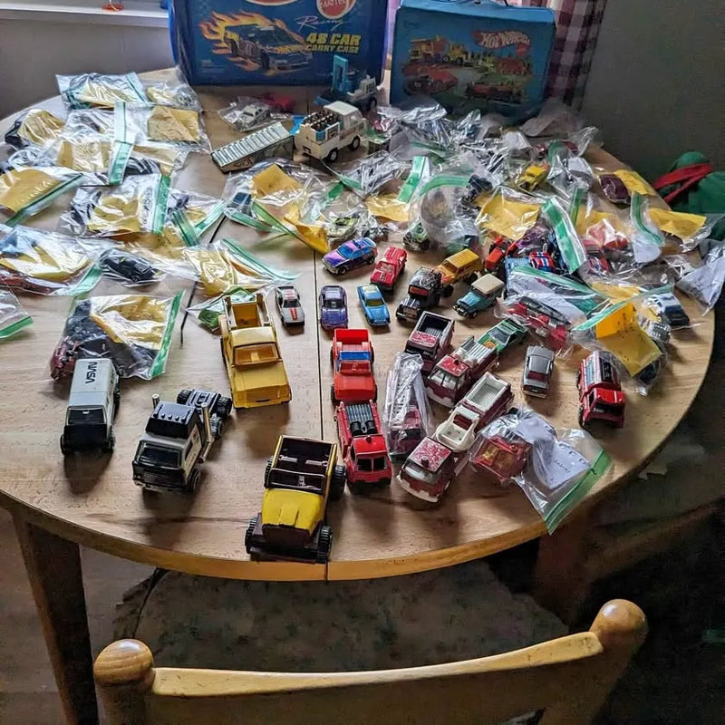 Diecast car set, assorted toy cars in clear bags on a tabletop