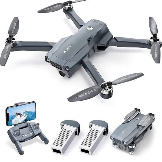 Foldable quadcopter drone with four propellers, camera body, and remote controller with smartphone.