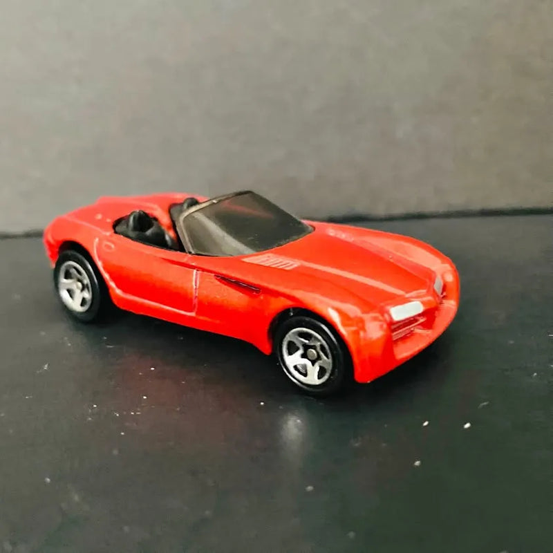 Red diecast sports car with black windshield and silver wheels