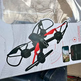 Black and red quadcopter drone with detachable prop guards and visible front camera