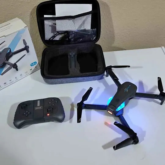 Black drone with blue LED lights and remote controller, in open hard case
