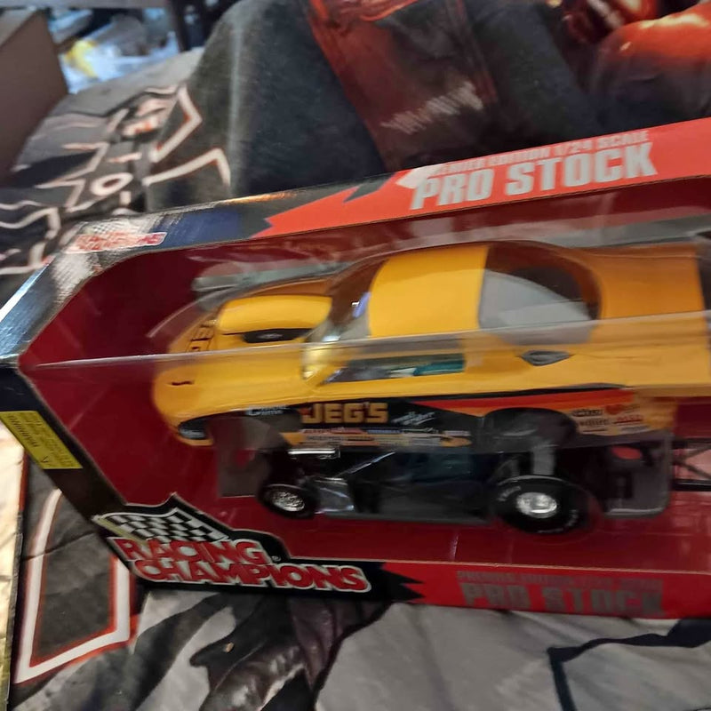 Yellow and black pro stock diecast car model in retail packaging, 1:24 scale