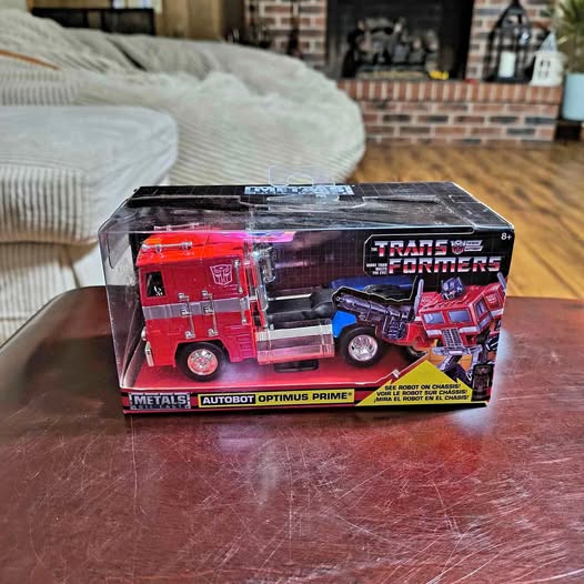 Diecast Optimus Prime truck in retail box, red cab and blue highlights