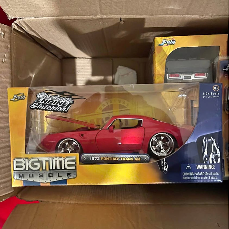Red 1:24 scale diecast muscle car in window retail box, front view