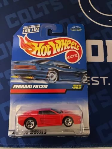 Hot Wheels 1:64 Ferrari F512M diecast in blister package, red car on card