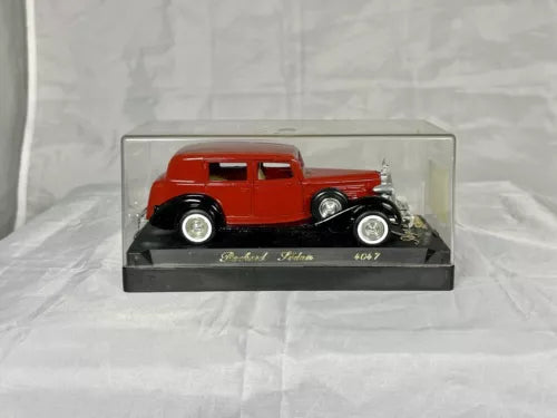 Red diecast sedan model in clear display case