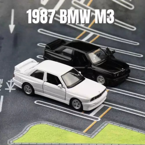 Alloy diecast model car, white and black BMW M3 sedan, front 3/4 view