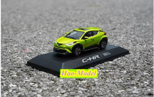 Green Toyota C-HR diecast model car on black display base with C-HR logo