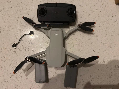 DJI Mavic Mini quadcopter drone with four propellers and camera housing