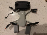 DJI Mavic Mini quadcopter drone with four propellers and camera housing