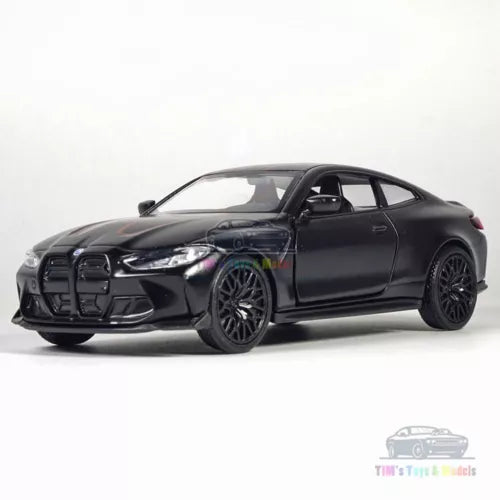 Black diecast model car, BMW M4 CSL style, front three-quarter view with alloy wheels.