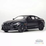 Black diecast model car, BMW M4 CSL style, front three-quarter view with alloy wheels.