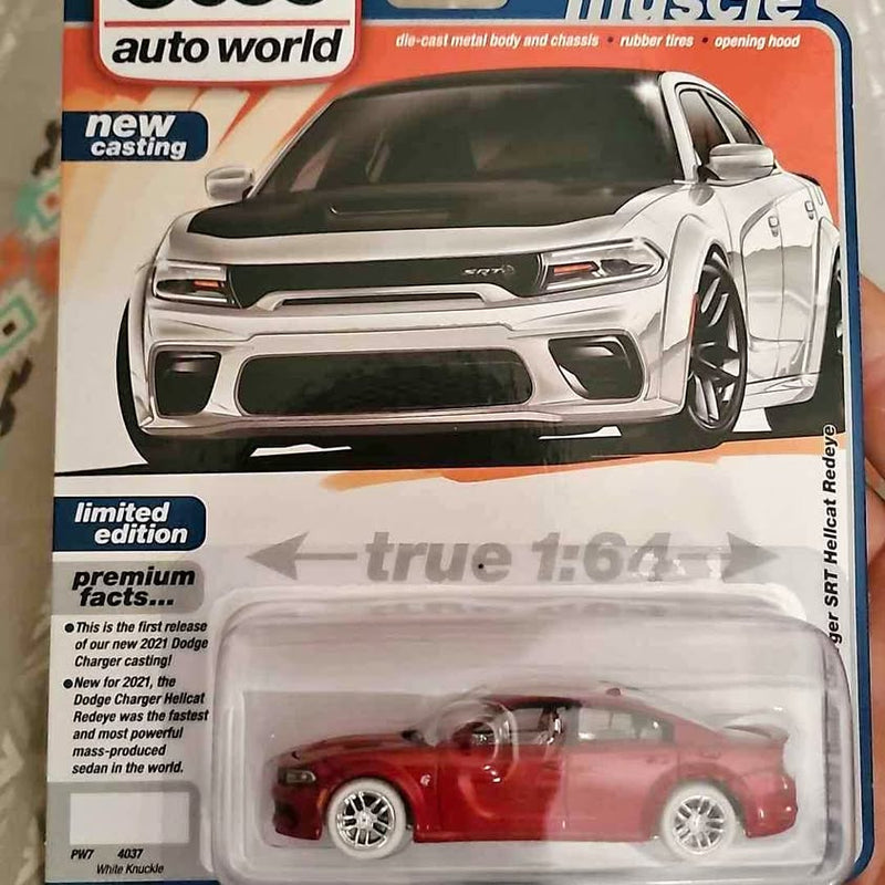 Red diecast model car in blister pack with gray card backing